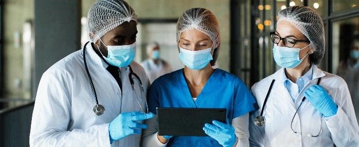 Health care workers looking at a tablet