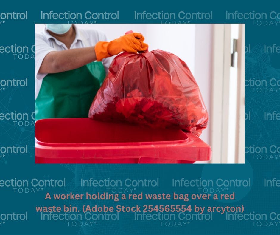 A worker is holding a red waste bag over a red waste bin.    (Adobe Stock 254565554 by arcyto)