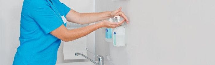 a health care worker washing her hands