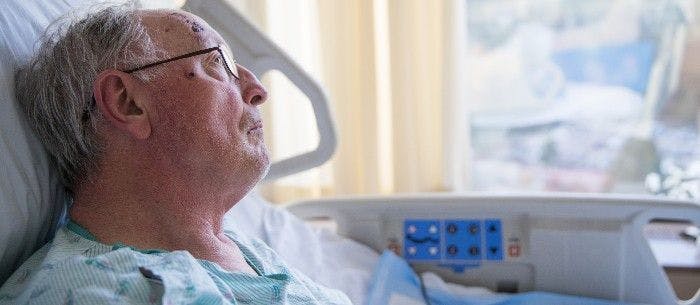 elderly man in hospital bed 