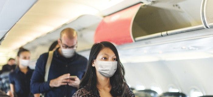 people on airplane with masks