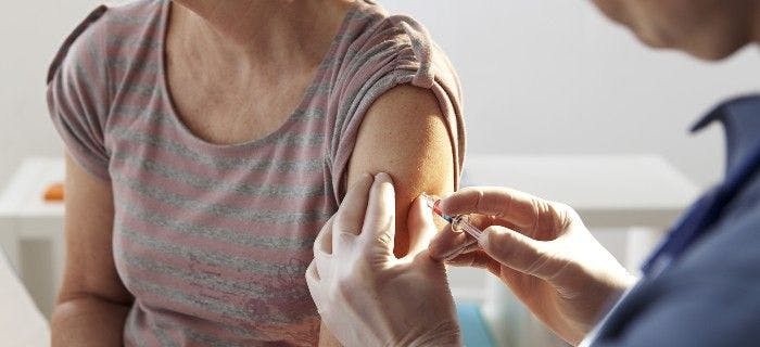 Adult woman receiving vaccine in arm