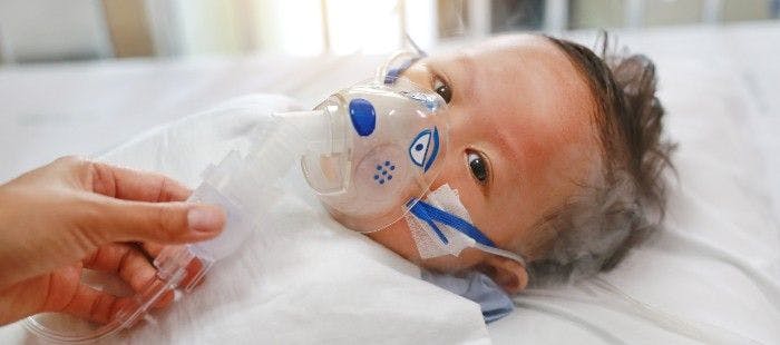 infant with oxygen mask