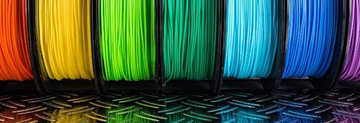 Colorful bright row of spool 3d printer filament.     (Adobe Stock 248686924 by stockphoto-graf)